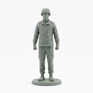 Detailed front-view studio photograph of a grey-green polymer miniature modern soldier wearing a helmet and tactical gear, standing on a circular base against a pure white background.